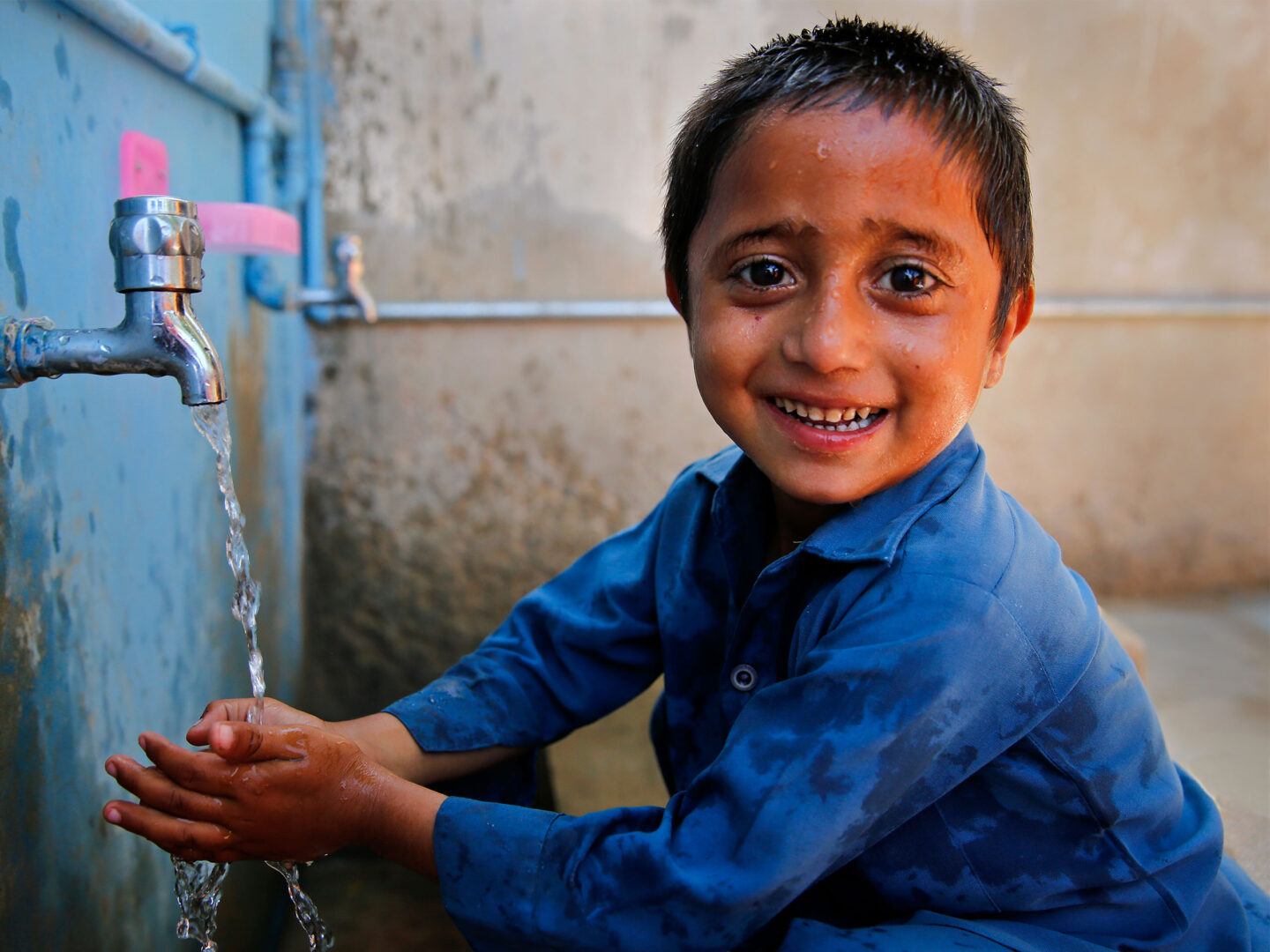 Boy in Pakistan washing his hands
